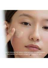 Woman applying a skincare product to her face with text about ingredients.