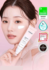 Woman holding a skincare product with awards displayed on a pink background