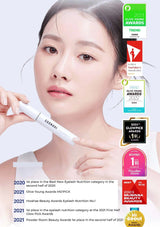 Woman holding an eyelash product with various awards displayed on a light gray background