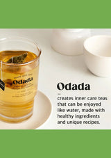 Glass of tea with Odada tea bag on a white surface, featuring the Odada brand.