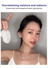 Woman with clear skin holding a white product against a gray background