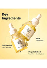 Two skincare droppers with key ingredients labeled on a yellow background