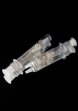 Two transparent plastic syringes on a black background