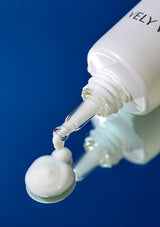 White cosmetic bottle with dropper against a blue background