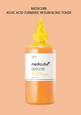 Medicube Kojic Acid Turmeric Resurfacing Toner bottle on a peach background