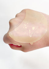 A box of K-Secret Extra Illuminating Eye Gel Patches with Vitamin C, showing the product name and patches in yellow color with a golden spatula.