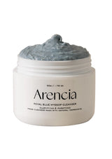 Jar of Arencia Royal Blue Hyssop Cleanser with grayish-blue scrub on a white background