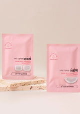 Two pink packages of Derm艾尔芙 dark spot solution patches on a light beige background