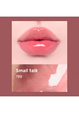 Close-up of a lip with a glossy pink lipstick labeled 'Small talk 789' on a beige background.