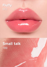 Close-up of a lip with a glossy pink lipstick labeled 'Small talk 789' on a beige background.