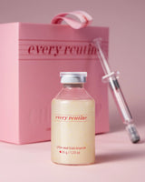 Skincare ampoule with syringe and pink box labeled 'every routine' on a pink background