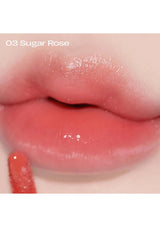 Close-up of lips with a glossy lip color labeled '03 Sugar Rose'.