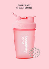 Pink Shakebaby shaker bottle with a flip-top lid and straw, shown on a solid pink background with the text 'SHAKE BABY SHAKER BOTTLE' at the top and a wire whisk illustration at the bottom right.