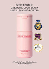 Pink bottle of 'Every Routine' stretch and glow black salt cleansing powder on a light pink background with certification logos.