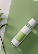 Skincare bottle with green label on a green background