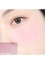 Close-up of a person's eye with a split background showing 'Taro Latte' color swatch.