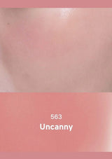 Close-up of skin with a pink border and '563 Uncanny' text.