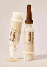 Skincare product with dropper and applicator on a light background