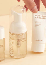 HEVEBLUE Salmon Caring Centella Special Travel Kit, including a bubble cleanser, toner, ampoule, and cream in a transparent plastic packaging with a handle.