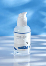 Skincare bottle with pump on a blue and white striped background