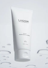White tube of Lagom cleanser on a light gray background with water droplets.