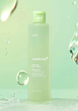 Medicube bottle on a green background with water droplets