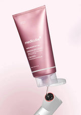 Pink tube of Medicube product with a white background
