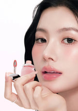 Close-up of a person holding a pink lipstick with a white background