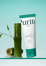 Tube of Purito Mighty Bamboo Panthenol Cream with a bamboo stick on a light blue background