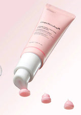 Pink skincare product with visible brand name on a light pink background