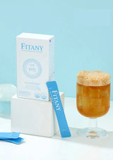 Fitany product packaging and a glass of iced tea on a light blue background