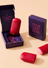 Red 'Cellu Light Stick' with packaging on a beige background