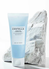 Blue skincare product with white label on a textured white background