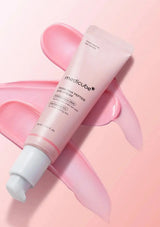 Medicube eye cream on a pink background