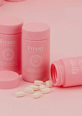 Pink 'Fitany' containers with pills on a pink background