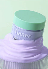 Flaner product with purple cream and green lid on a light green background