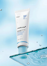 Medicube skincare product with water droplets on a blue background