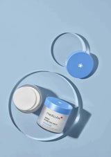 Two jars of Medicube skincare product on a light blue background
