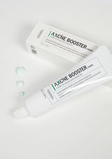 Acne Booster cream tube and packaging on a white background