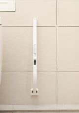 White kitchen cabinet handle on a beige cabinet