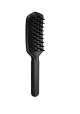 Black hairbrush on a white background