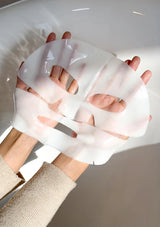 Person wearing a white silicone glove on a plain background