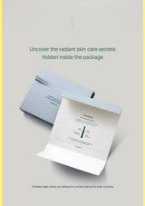 A skincare booklet or guide shown partially opened from inside a light blue envelope, with marketing text above reading 'Uncover the radiant skin care secrets hidden inside the package' on a pale gray background.