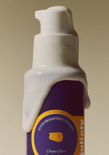 White bottle with a purple label on a beige background