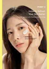 A close-up beauty ad showing a woman applying or touching a white cream on her cheek against a warm beige background, with yellow side borders and text reading 'POINT 3 Instantly Refresh Your Skin Barrier' and 'panthenol'.