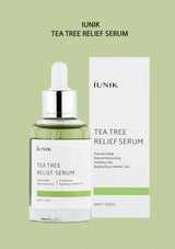 IUNIK Tea Tree Relief Serum bottle and packaging on a green background
