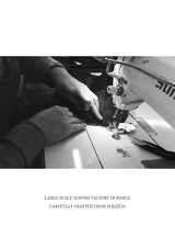 Person working on a sewing machine with text about a large-scale sewing factory in Korea.