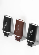 Three hairbrushes with black and brown handles on a white background