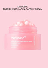 Pink container with pearl-like beads and a spoon on a white background