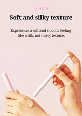 A close-up of two hands holding and demonstrating a white textured personal care item against a pale pink background, with overlaid text reading 'Point. 3 Soft and silky texture' and descriptive copy about a smooth silk-like feeling.